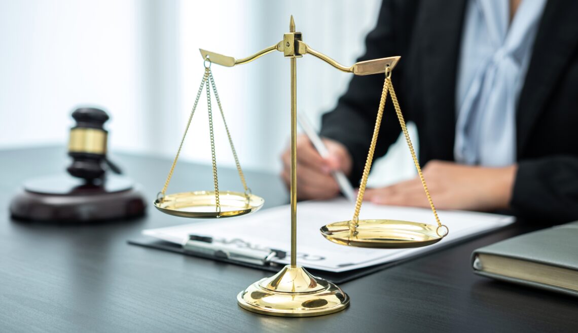 Female lawyer working with legal case document contract in offic