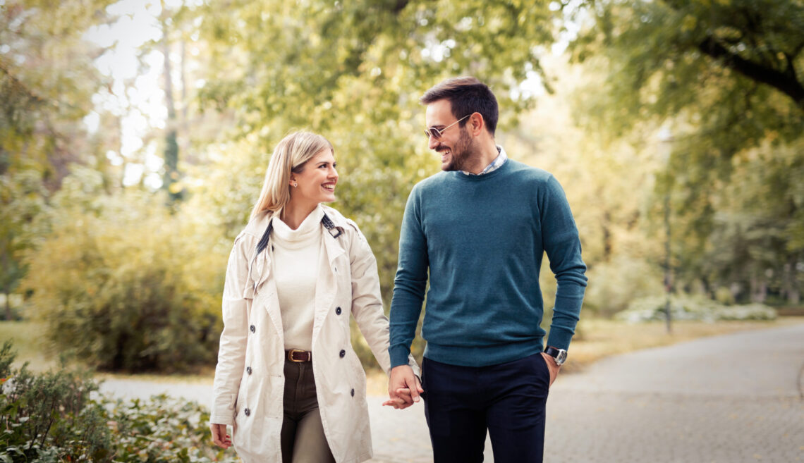 Young beautiful couple in love walking together
