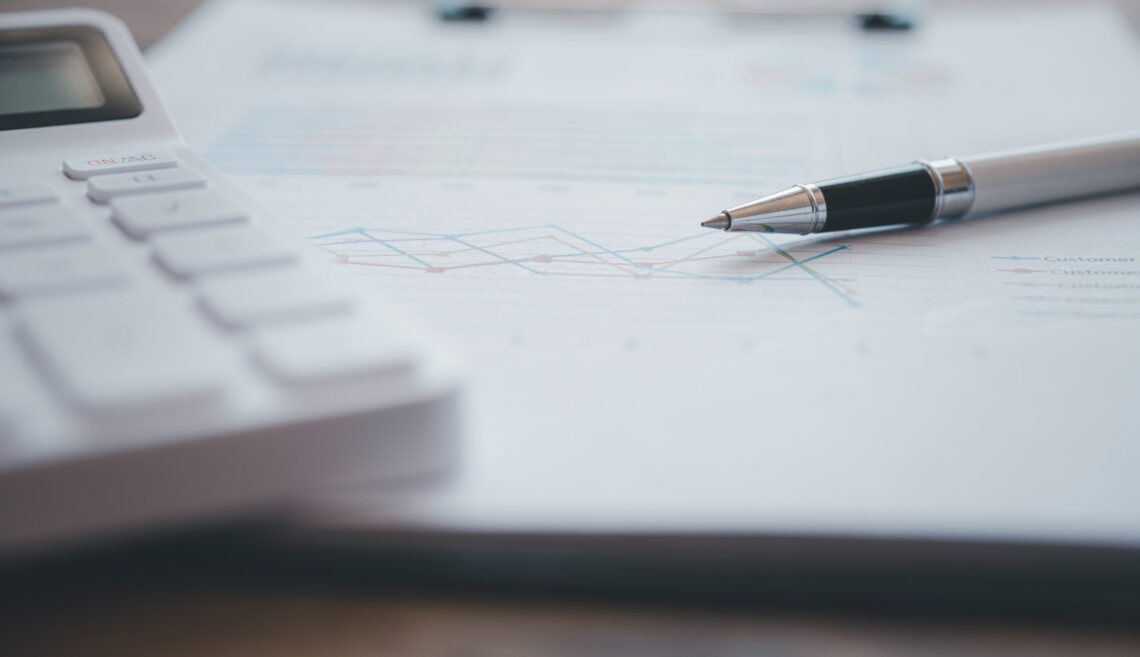 Close-up of financial figures with a calculator and a pen .finan