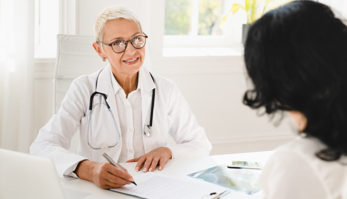 Gynecologist prescribing medicines, health insurance with female patient during hospital appointment
